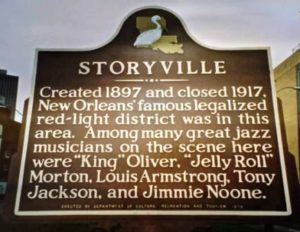 Historic Marker for Storyville, New Orleans (Red Light District).  Sign reads: "Created 1897 and closed 1917, New Orleans' famous legalized red-light district was in this area.  Among many great jazz musicians on the scene here were "King" Oliver, "Jelly Roll"" Morton, Louis Armstrong, Tony Jackson, and Jimmie Noone."